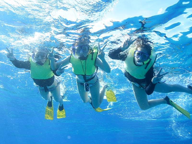 three people snorkeling