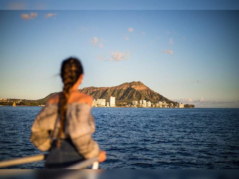 Girl looking at Diamond Head from boat