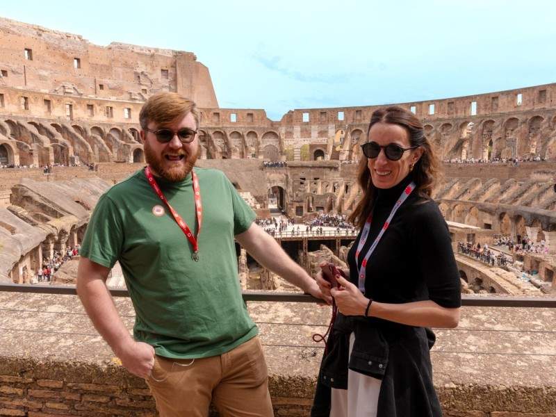 Two tourists standing on the 2nd level of the Colosseum while on tour with The Tour Guy.