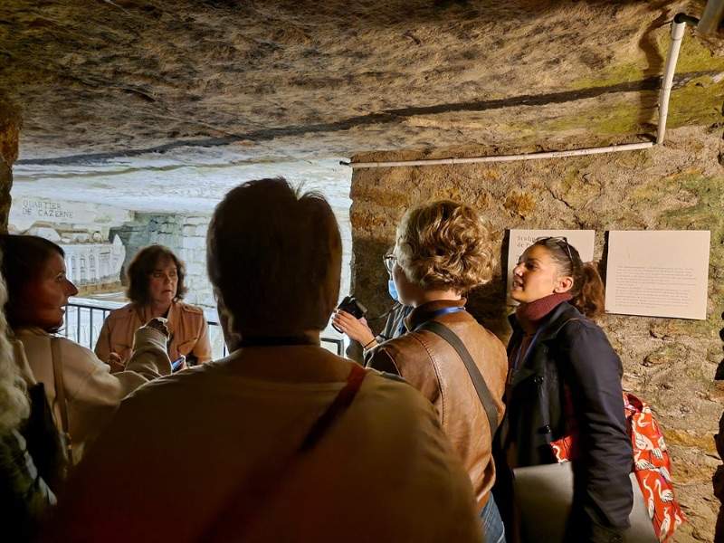 Group of people talking in the catacombs 