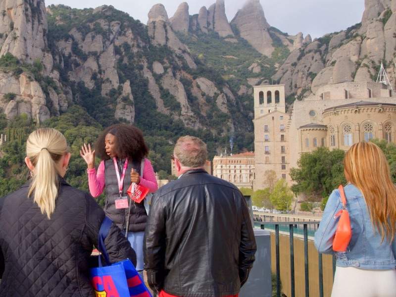 Tour guide with people looking at Montserrat 