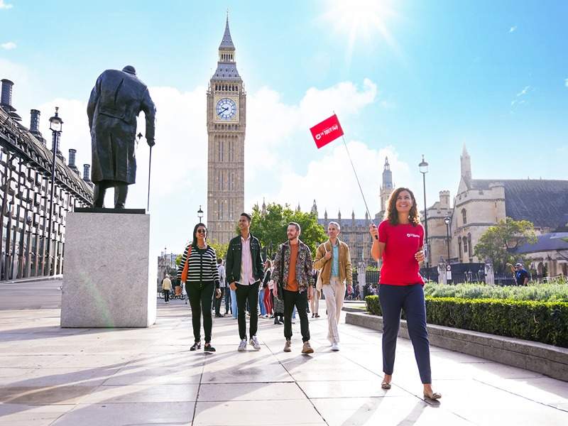 A group of tourists walking in Parliament Square with Big Ben in the background while on tour with The Tour Guy.