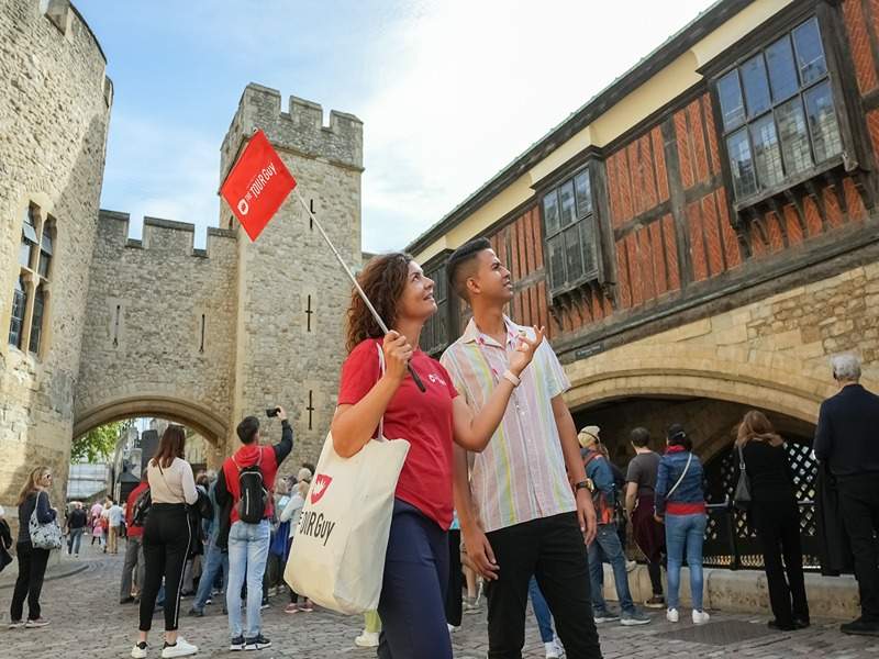 A tourist walking through the Tower of London with his guide from The Tour Guy.