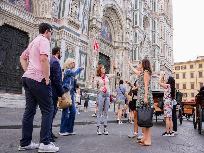 A group of tourists in front of the Florence Cathedral with a guide from The Tour Guy.