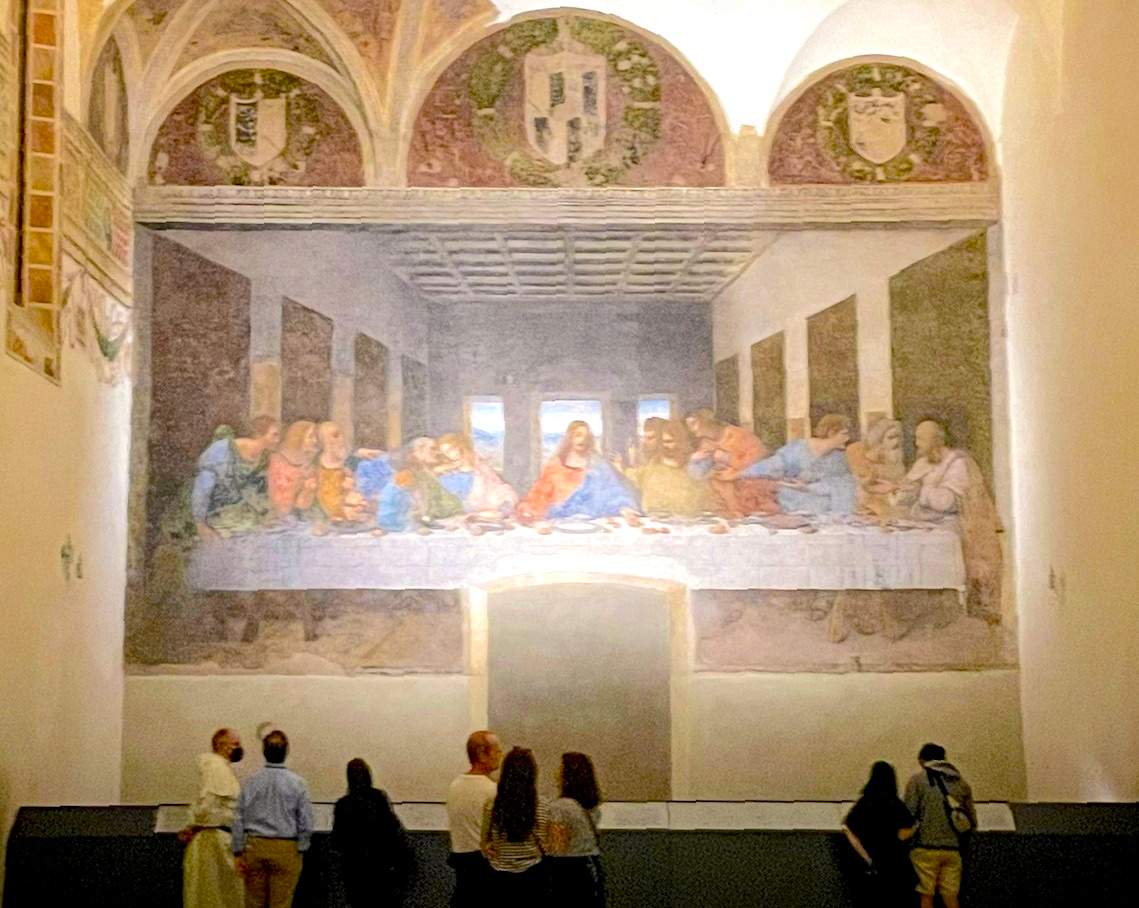 people standing in front of the last supper