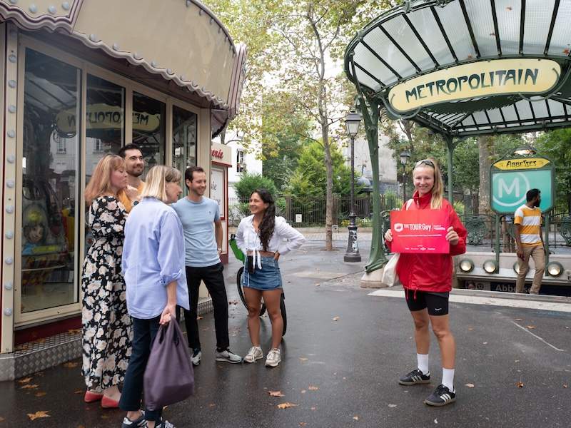 A group of tourists outside the Pierre Herme store in Paris with a guide from The Tour Guy.