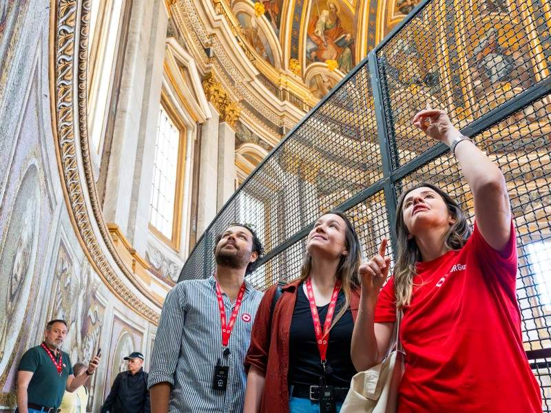 A pair of tourists inside the first level of St. Peter's Dome with their guide from The Tour Guy.