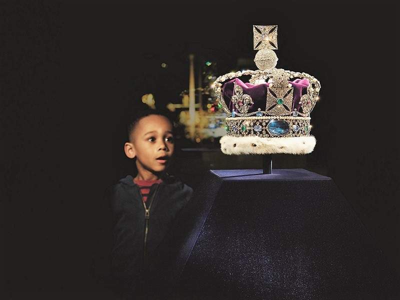 A young boy looking at the British Royal Crown in the Tower of London.