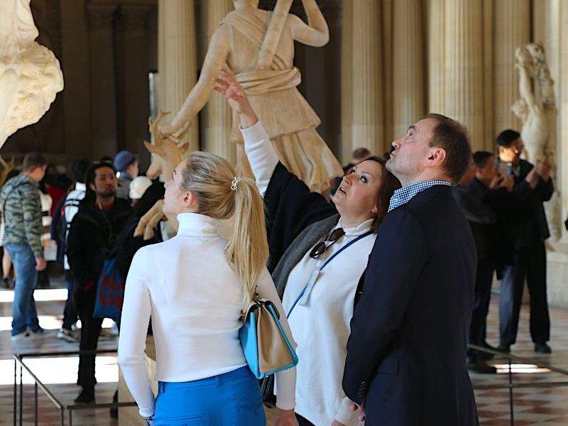 A group of tourists in the Louvre Museum.