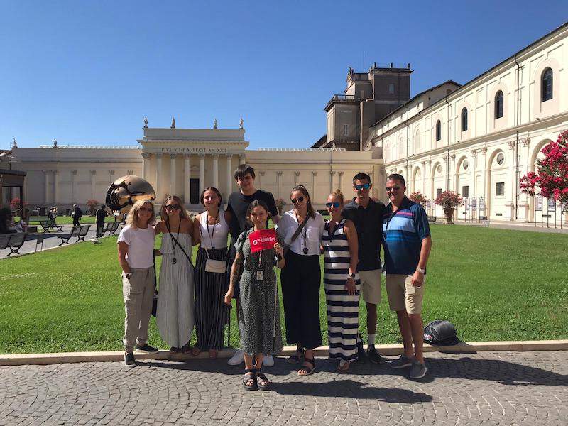 guide and group in pinecone courtyard