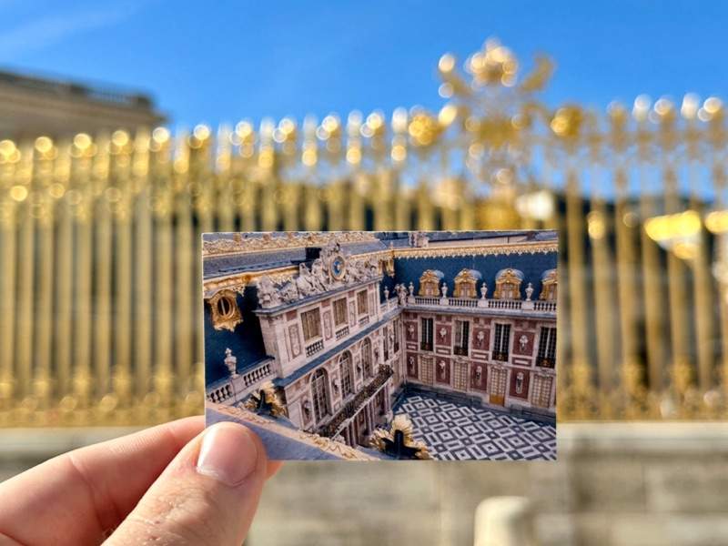 Palace of Versailles ticket with golden gates behind