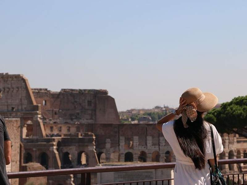 A woman looking at the Colosseum.