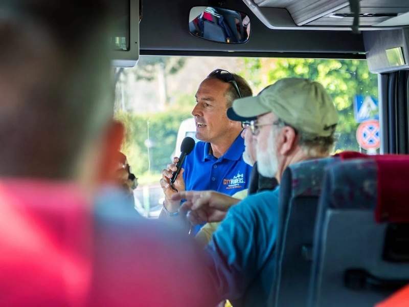 A person speaking into a microphone on a bus