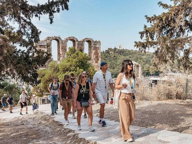 guide and group walking near the acropolis