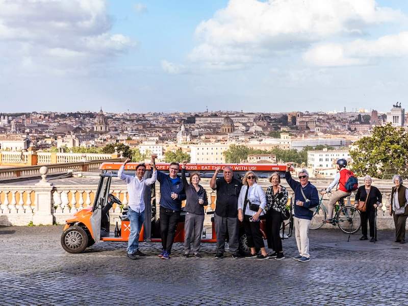 A group of people posing for a photo in front of a Golf Cart on Gianicolo Hill