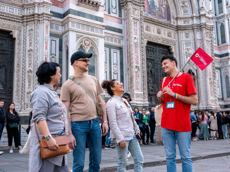 A group of tourists in front of the Florence Cathedral with a guide from The Tour Guy.