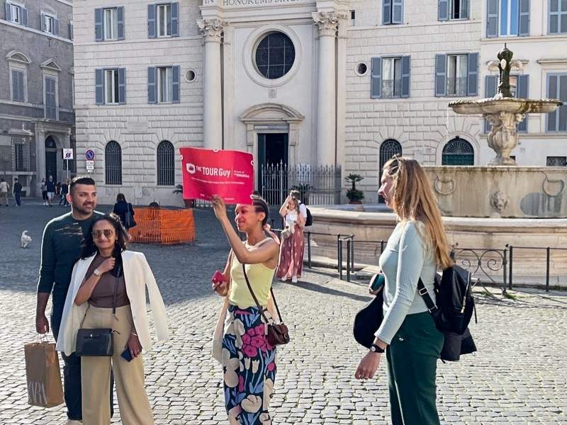 A group of tourists in Piazza Farnese with their guide from The Tour Guy.