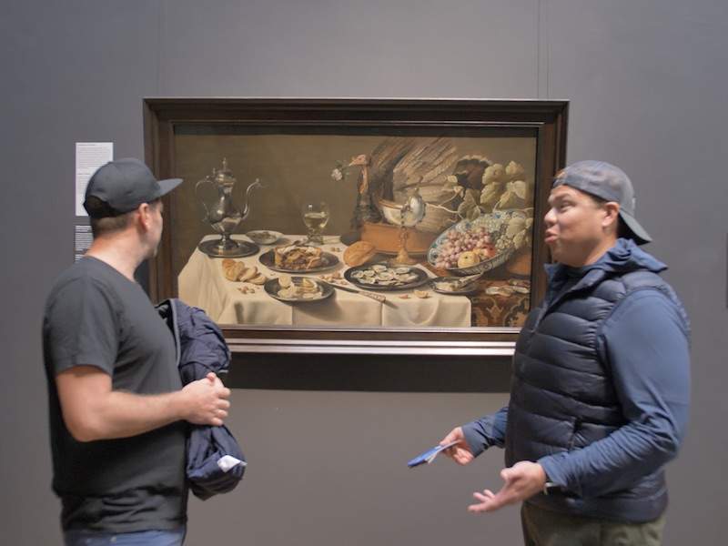 Rijksmuseum painting in background