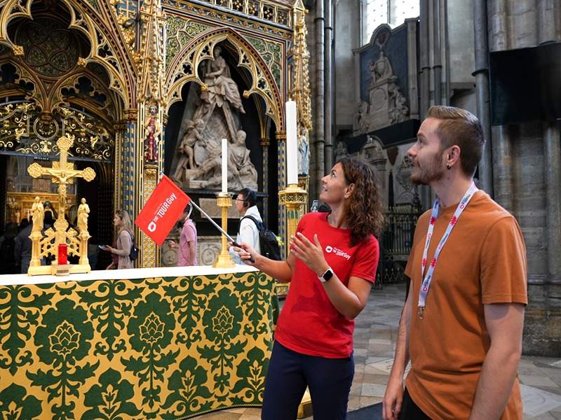 A man looking at golden arches inside Westminster Abbey with his guide from The Tour Guy.