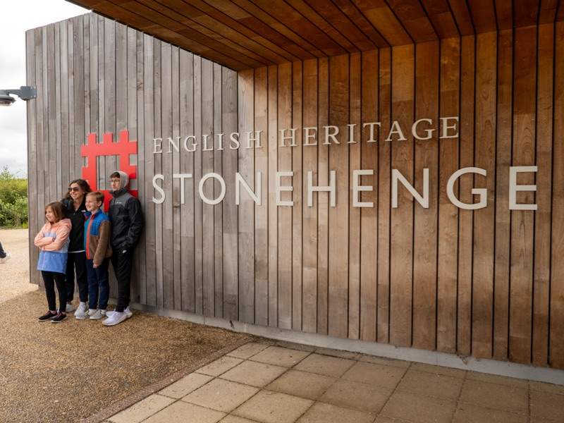 Family posing in front of Stonehenge Visitor Center