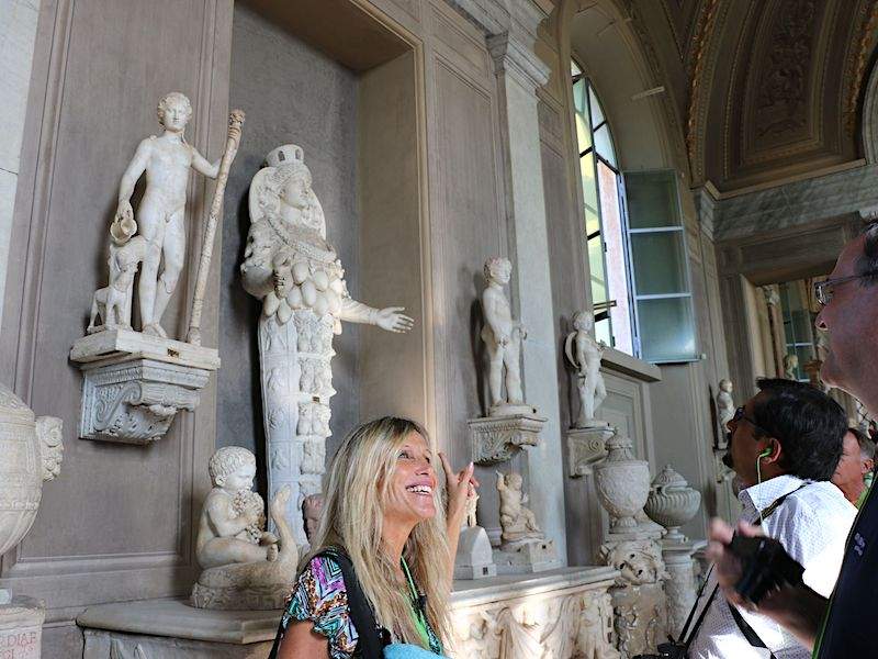 A group of tourists inside the Vatican Museums.