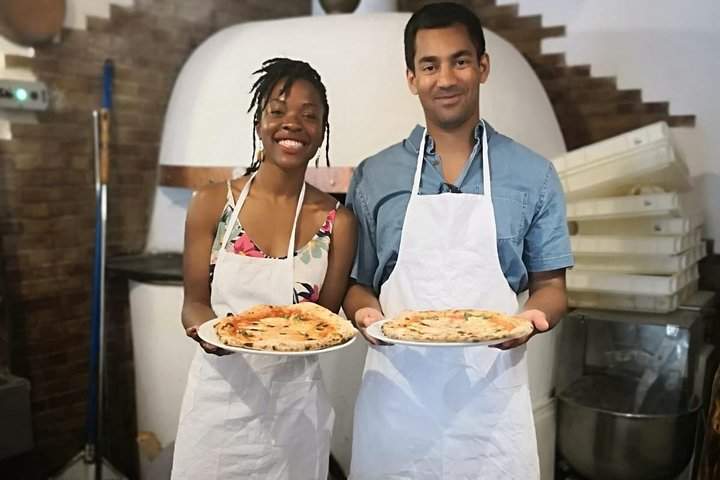 couple holding pizzas class