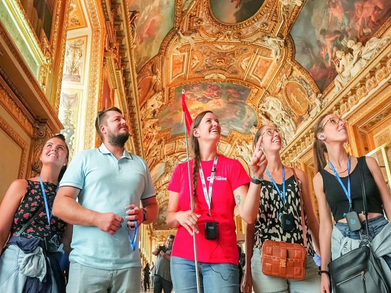 A tour group inside the Louvre Museum with their guide from The Tour Guy.