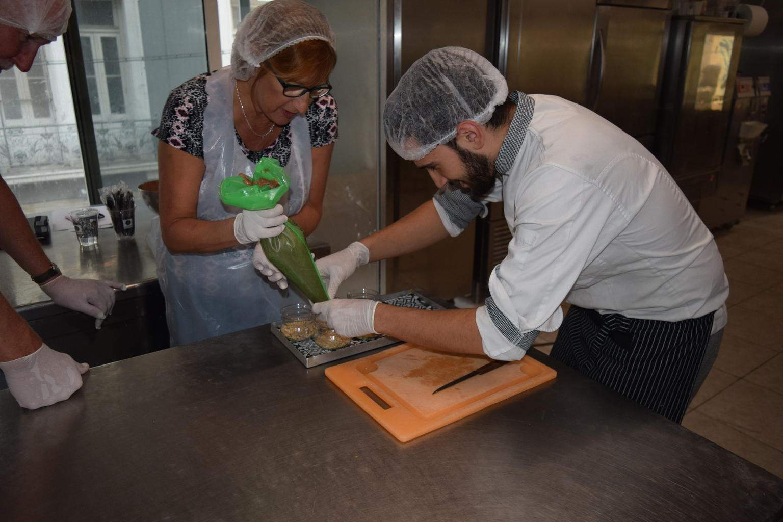 Cooking class participants using pipe bag