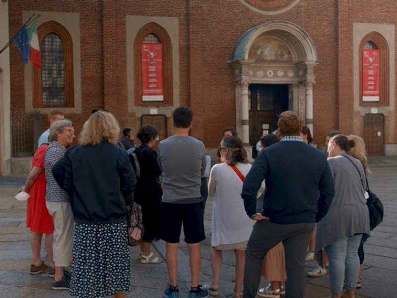 people and tour guide in front of Santa Maria delle Grazie