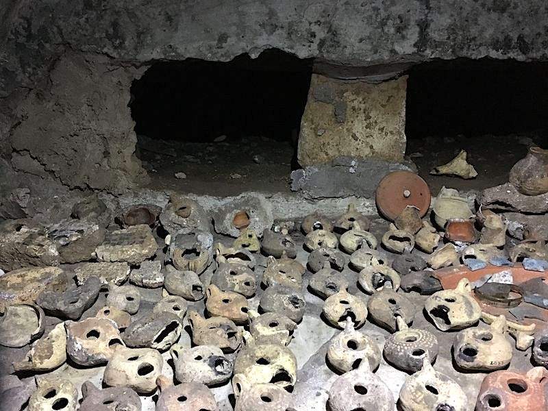An image of ancient pottery inside the catacombs in Rome.