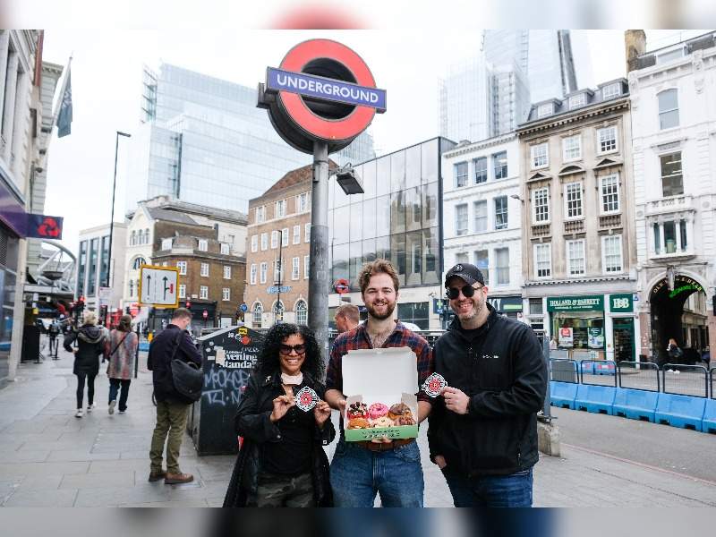 People outside of Underground with donuts