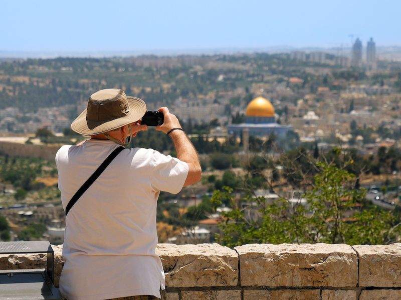 man taking picture of dome of the rock