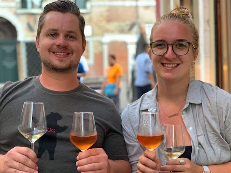 Couple holding two glasses of wine