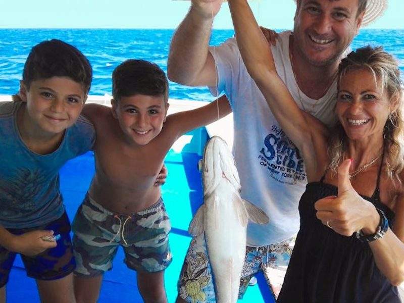 Family holding a fish