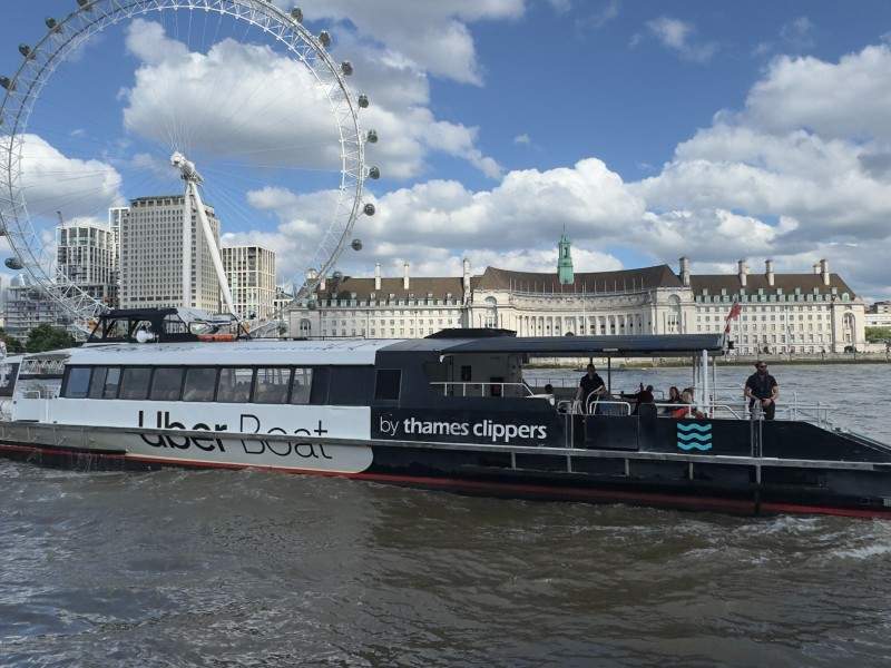 An image of a Thames River Boat on the Thames with the London Eye in the background.