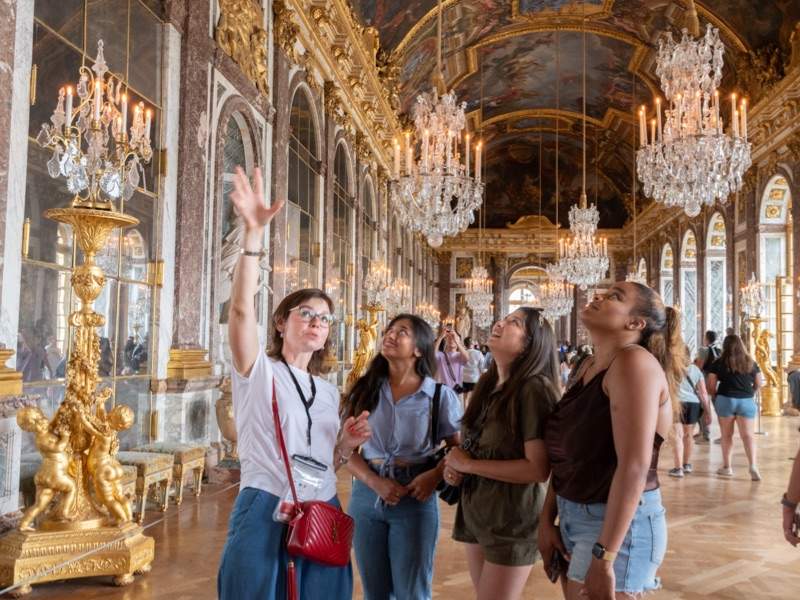 The Tour Guy tour guide and customers at Versailles in the Hall of Mirrors