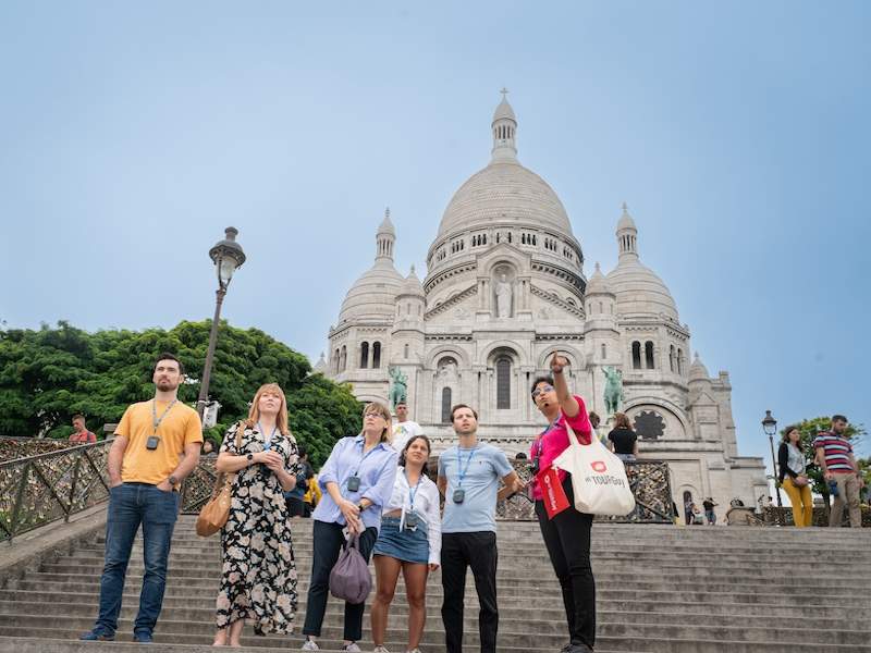 A tour group in front of the Sacre Coeur Basilica with a guide from The Tour Guy.