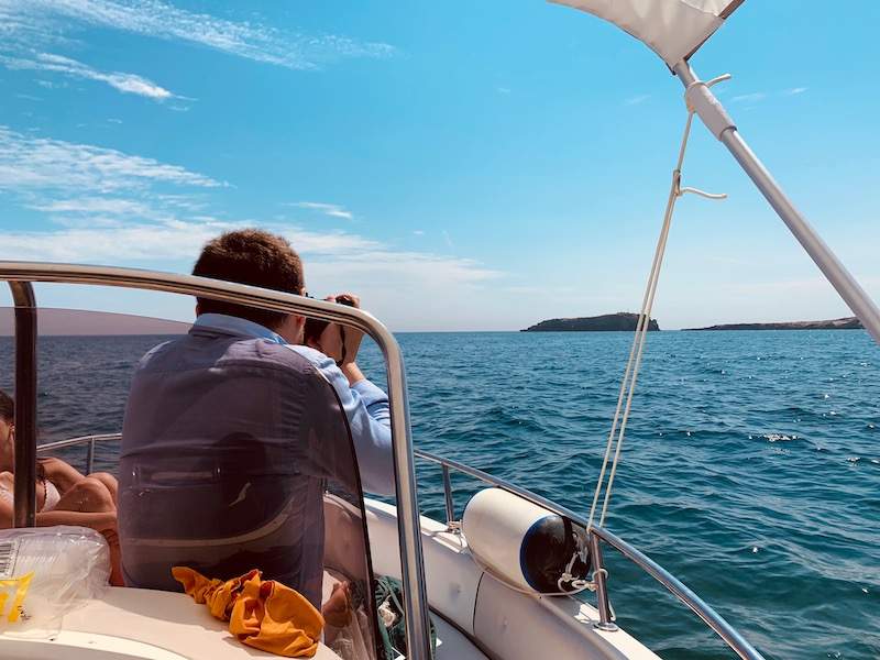 Man taking picture of island in distance