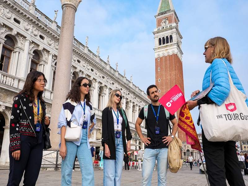 Tour guide and group walking in Venice 