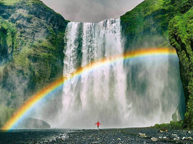 person standing at Iceland Skogafoss Falls