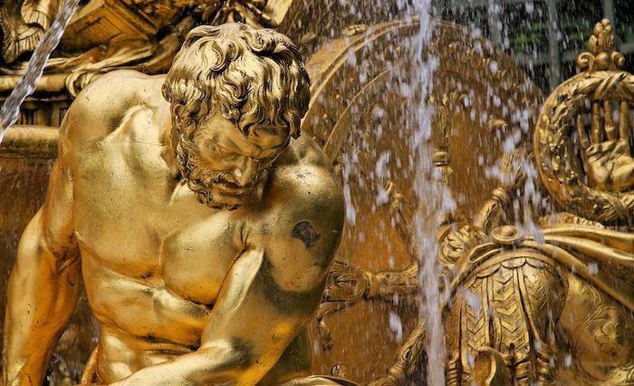 close up of a golden statue water fountain feature at Versailles, France