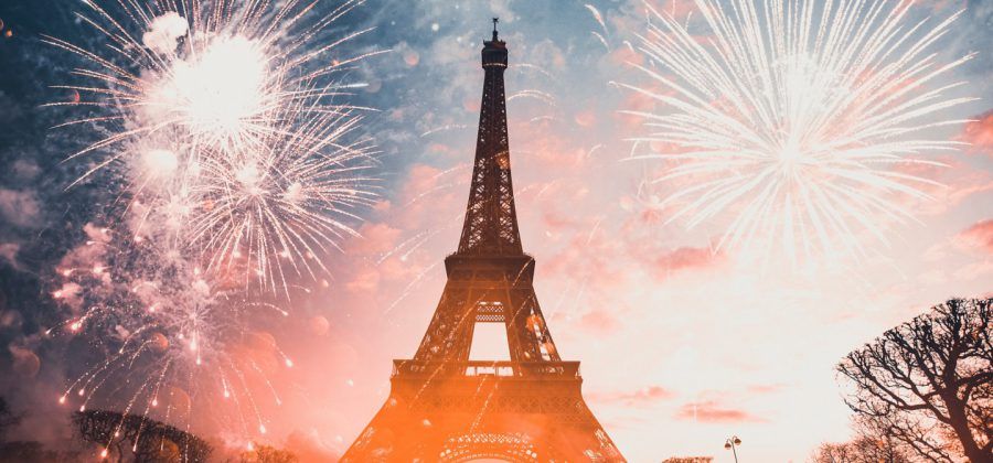 Fireworks blasting next to the Eiffel tower in Paris.