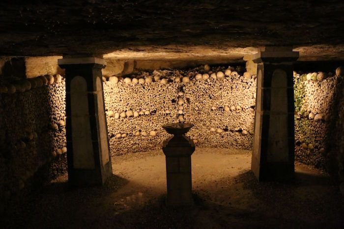 Interior of the Paris Catacombs with a wall of arranged human bones