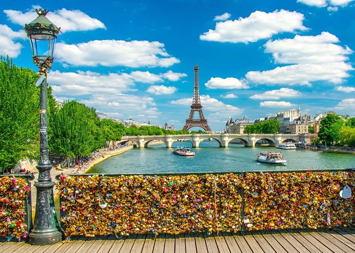 Sunny day on "Pont des arts" at Paris with an amazing view of Tower Eiffel