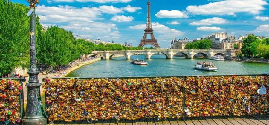 Love Lock Bridge in the foreground with the Eiffel Tower in the background in Paris.