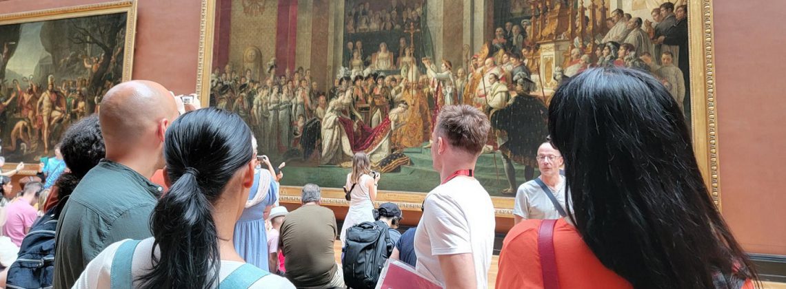 people and guide looking at coronation of napoleon