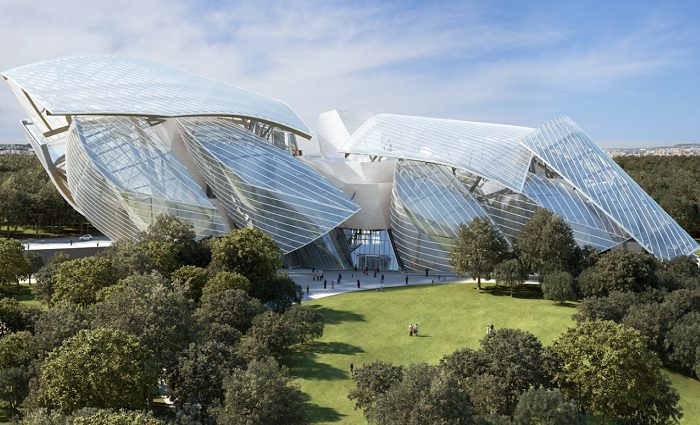 exterior of the louis Vuitton foundation and its exquisite modern architecture surrounded by luch gardens and people visiting the museum