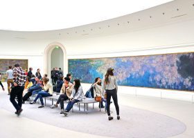 Visitors admire the giant waterlily Nympheas paintings by impressionist painter Claude Monet at the Musee de l Orangerie museum in Paris.