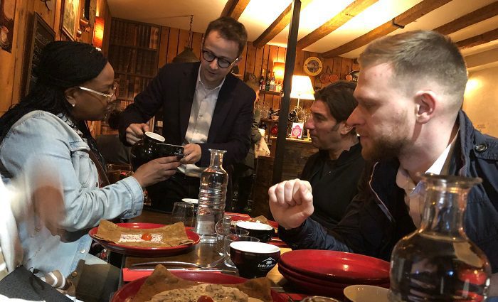 waiter serving guests at restaurant in Paris