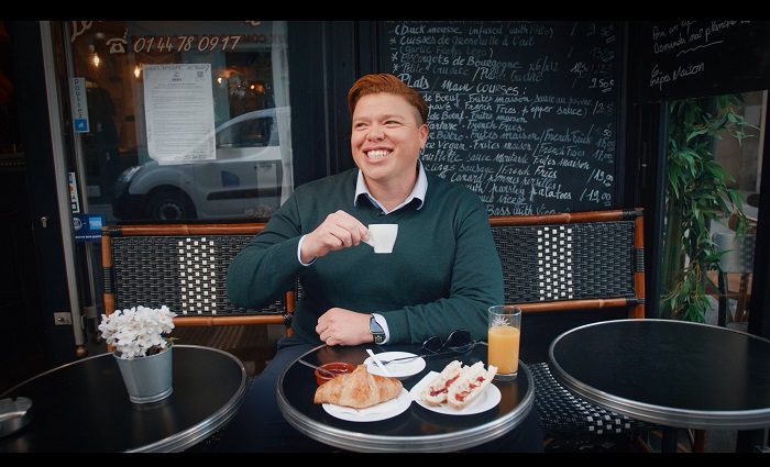 man drinking coffee and having breakfast at a Paris cafe